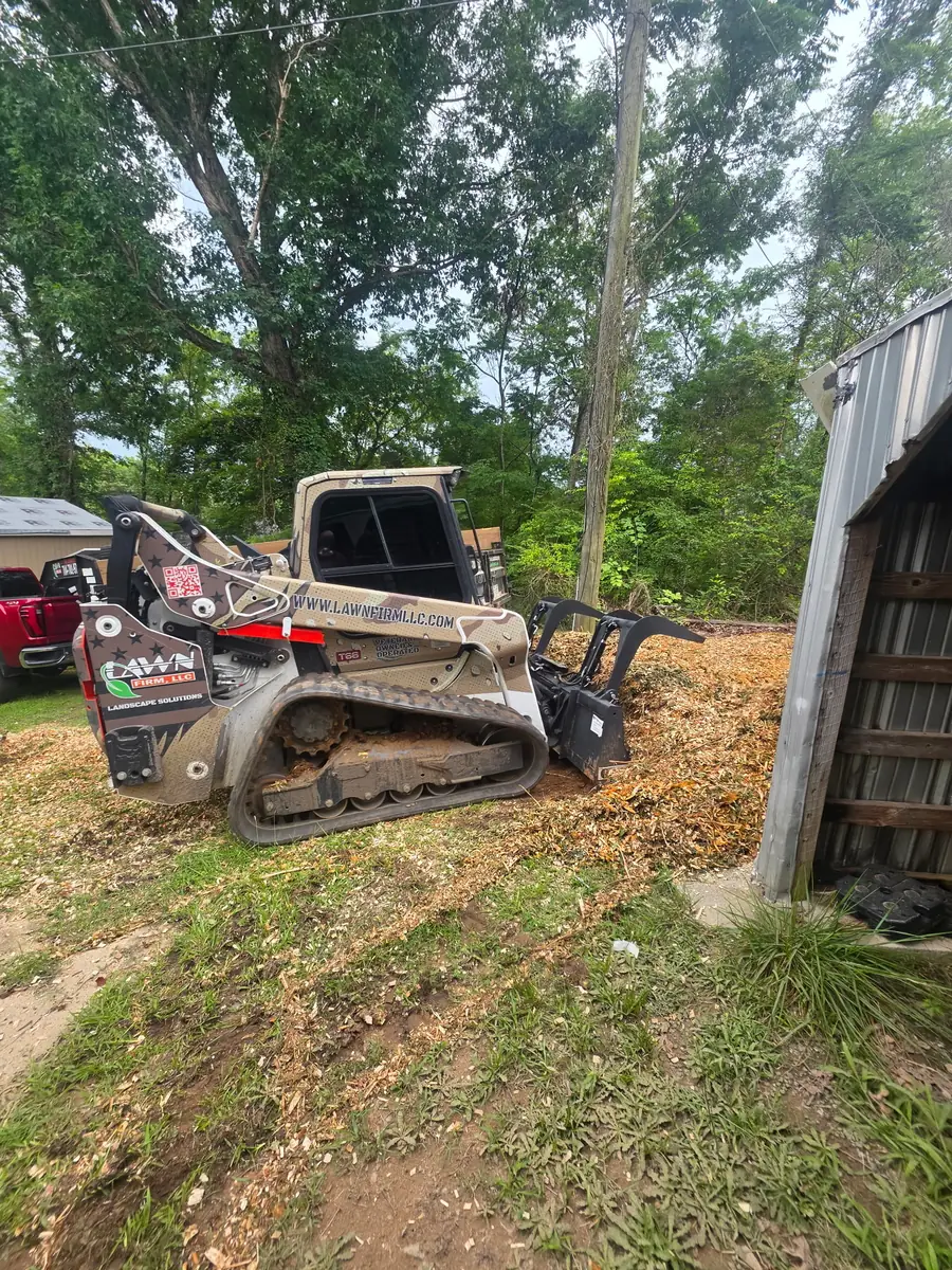 Land clearing equipment working a wooded hillside lot in Concord, NC