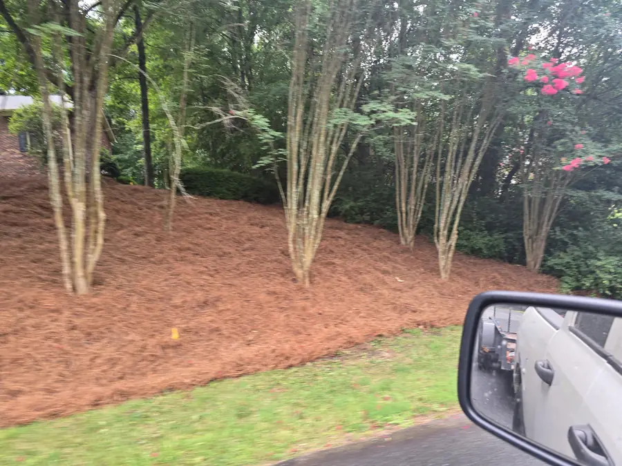 Black mulch installation along a brick home foundation in Concord, NC