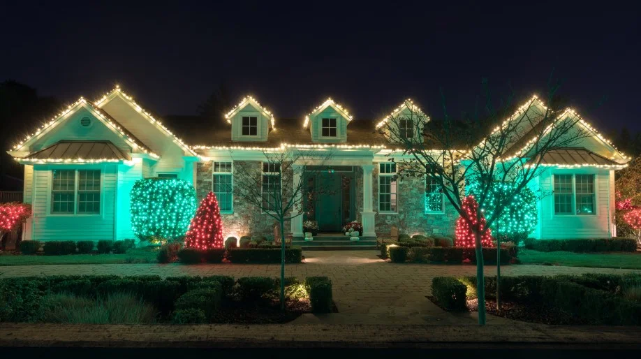 Custom-colored holiday lighting display on a home